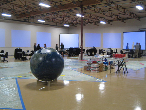 Prototype Event set up — Twelve large screens surrounding 70′x35′ Dymaxion Map. Prototype Event set up — Twelve large screens surrounding 70′x35′ Dymaxion Map.