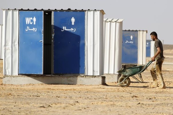 A Jordanian worker uses a wheelbarrow to transport materials for building the Azraq Syrian Refugee Camp, the third of its kind, near Al Azraq, 80km (50 miles) east of Amman A Jordanian worker uses a wheelbarrow to transport materials for building the Azraq Syrian Refugee Camp, the third of its kind, near Al Azraq, 80km (50 miles) east of Amman