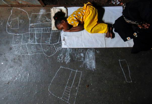 Noor Jahan, 5, sleeps on chalk drawings she made as her mother begs for alms at a railway station in Mumbai, on Dec. 7, 2012. REUTERS/Danish Siddiqui Noor Jahan, 5, sleeps on chalk drawings she made as her mother begs for alms at a railway station in Mumbai, on Dec. 7, 2012. REUTERS/Danish Siddiqui