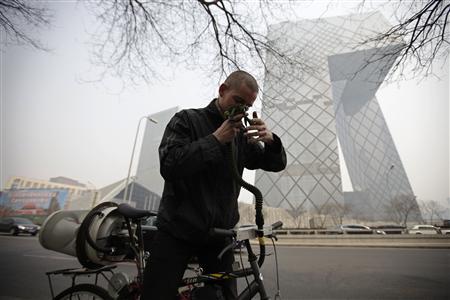 Artist Matt Hope adjusts the helmet linked to his air filtration bike in front of the China Central Television (CCTV) building on a hazy day in Beijing, March 26, 2013. Photo: Petar Kujundzic Artist Matt Hope adjusts the helmet linked to his air filtration bike in front of the China Central Television (CCTV) building on a hazy day in Beijing, March 26, 2013. Photo: Petar Kujundzic