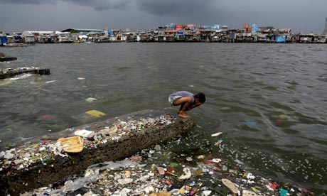 A Filipino boy washes his face in murky waters in Manila. Inaction on the environment will accelerate global poverty, warns the UN. Photograph: Francis R Malasig/EPA A Filipino boy washes his face in murky waters in Manila. Inaction on the environment will accelerate global poverty, warns the UN. Photograph: Francis R Malasig/EPA