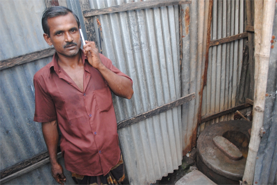 Abdul Malik, a 35-year-old rickshaw puller from Dhaka, shares a communal toilet with six families in the slums. Mobile phone usage has surged in recent years, while latrine usage has lagged  Abdul Malik, a 35-year-old rickshaw puller from Dhaka, shares a communal toilet