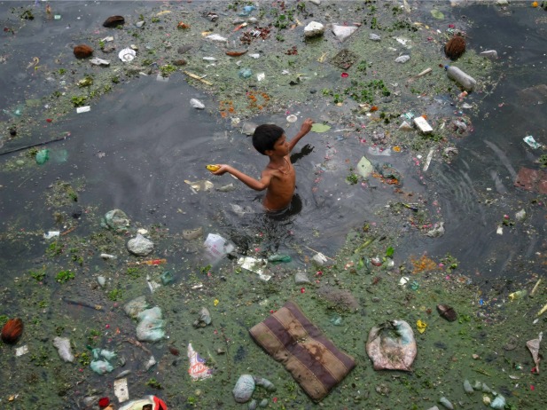 A boy wades through polluted waters in Ahmedabad, India, July 2013 A boy wades through polluted waters in Ahmedabad, India, July 2013